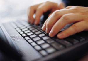 Hands at Computer Keyboard