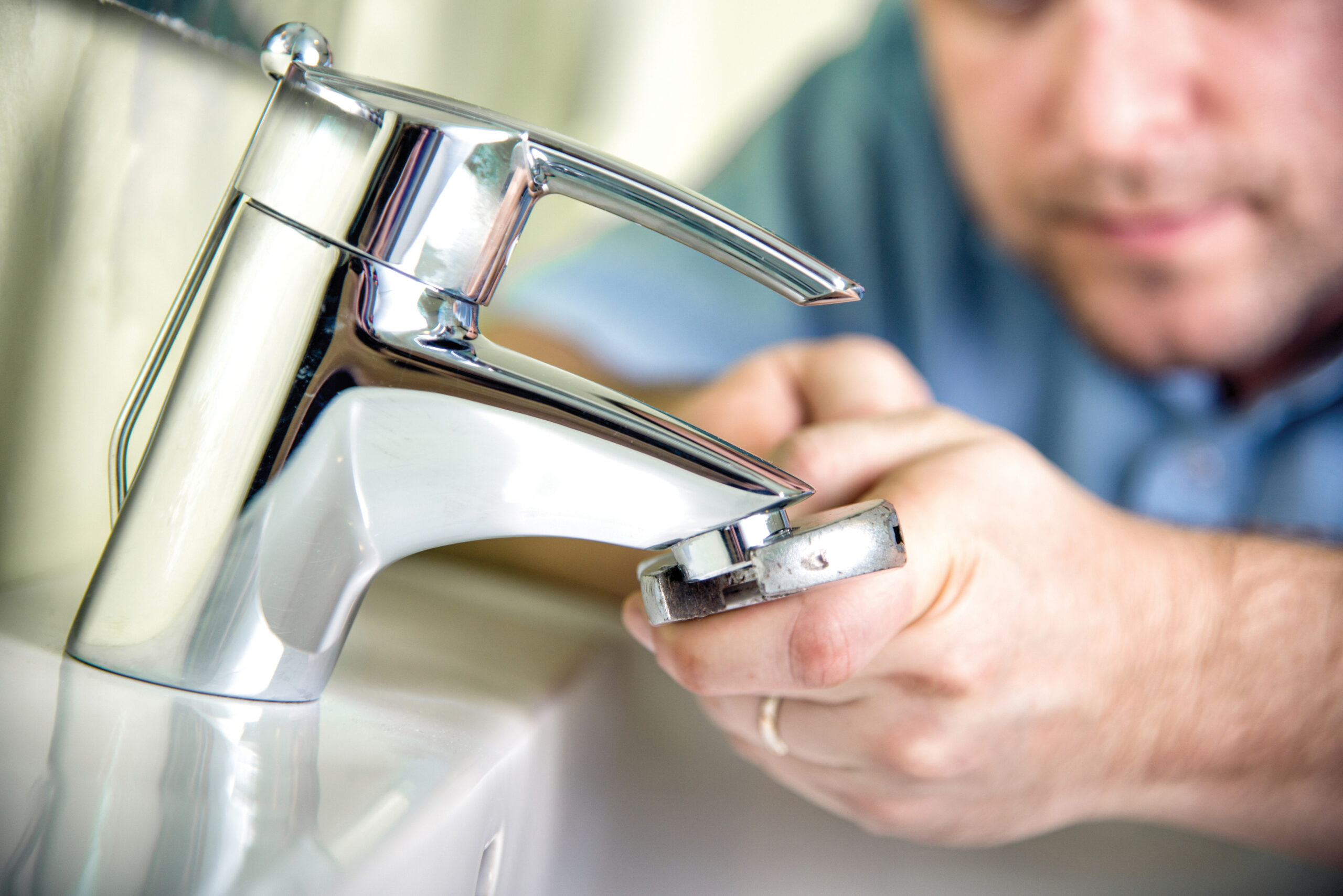Plumber fixing a faucet