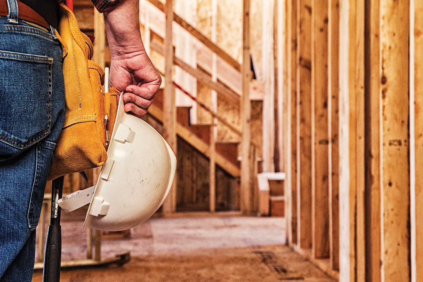 Builder holding hard hat